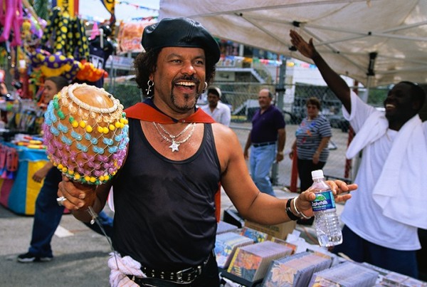 March 1998, Miami, Florida, USA --- A man plays a musical instrument made from a gourd during the Calle Ocho Festival. --- Image by © Tony Arruza/CORBIS